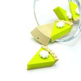 3D key lime pie charm with detailed crust and whipped topping, displayed on a white background.