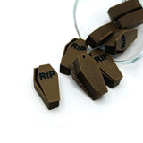 3D brown coffin charm with engraved silver cross detail, displayed on a white background.