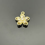 A gold-tone brass flower charm encrusted with micro pave cubic zirconia, measuring approximately 10 × 9 mm