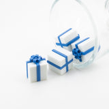 Miniature 3D blue-bow gift-box charm, approximately 13×13 mm, with a loop for attachment, displayed on a white background.