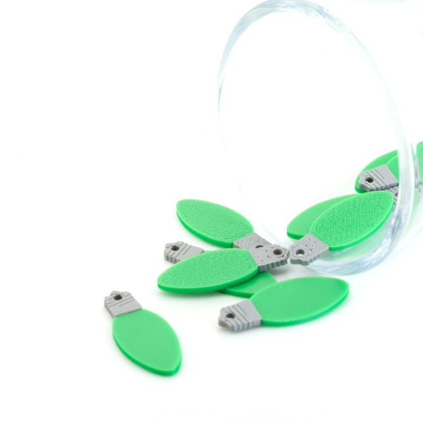Green miniature Christmas light-bulb charm, approx. 10×25 mm, with loop for hanging, displayed on a white background.