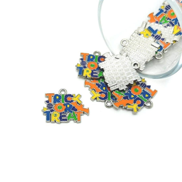 Colorful 'Trick or Treat' and Halloween-themed charms on a white background