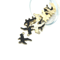 Gold and black bird-shaped charms on a white background
