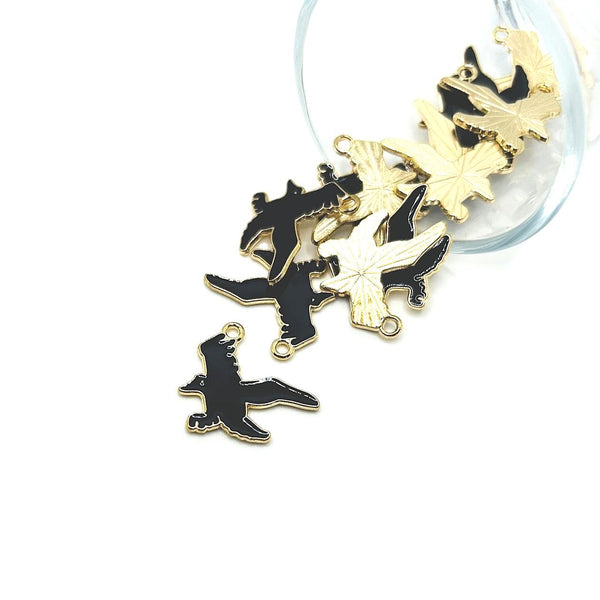 Gold and black bird-shaped charms on a white background