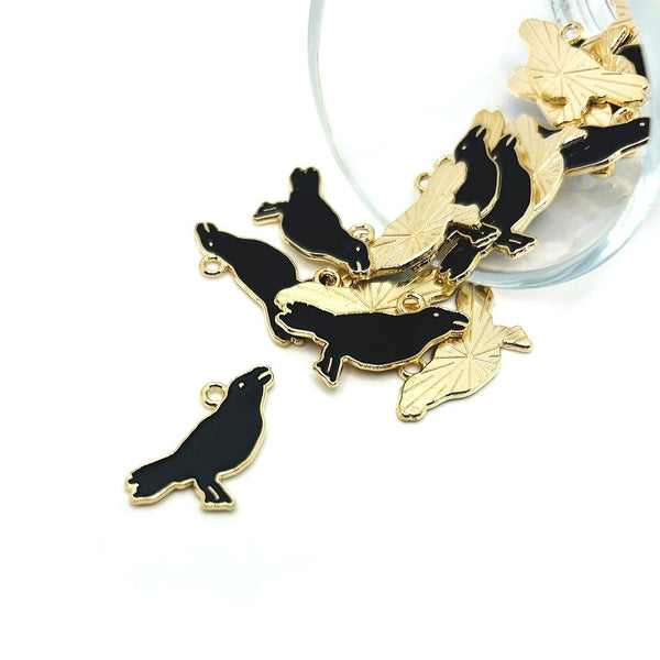 Black enamel raven (or crow) charm with gold-tone outline and detailed features, about 22×17 mm, displayed on a white background.