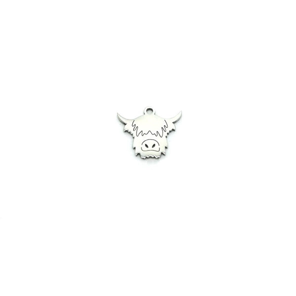 Silver pendant shaped like a Highland cow on a white background
