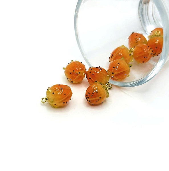 Small flower bud charm in orange enamel with gold-tone edges and an attachment loop, approximately 14×9 mm, shown on a white background.
