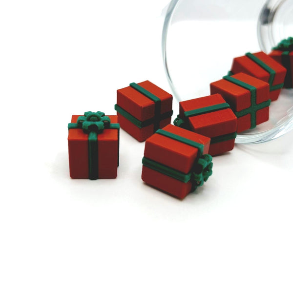 Red present charm with green ribbon detail, about 13×13 mm, shown on a white background.