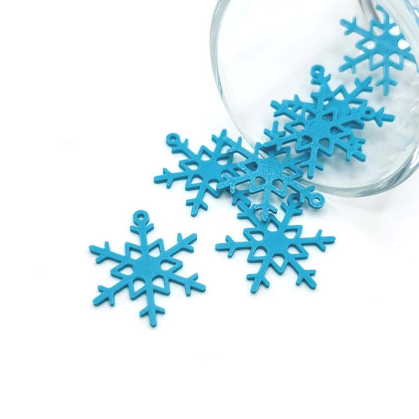 Blue snowflake charm with intricate cut-out design, approximately 22×26 mm, displayed on a white background.