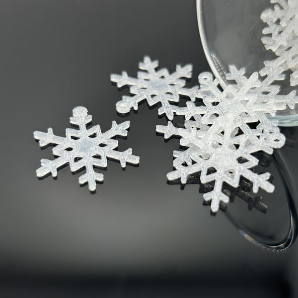Decorative snowflake earrings on a dark background