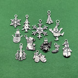 Collection of silver Christmas-themed charms on a green background