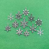 Silver snowflake-shaped charms on a green background