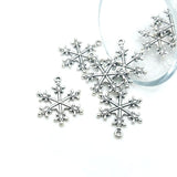 Silver snowflake ornaments on a white background