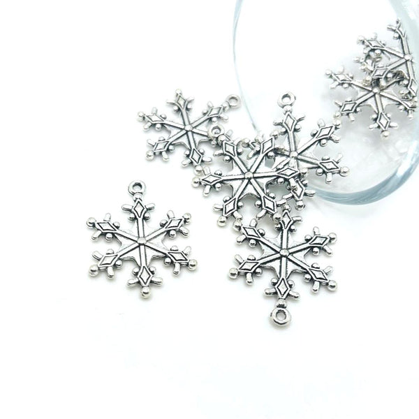 Silver snowflake ornaments on a white background