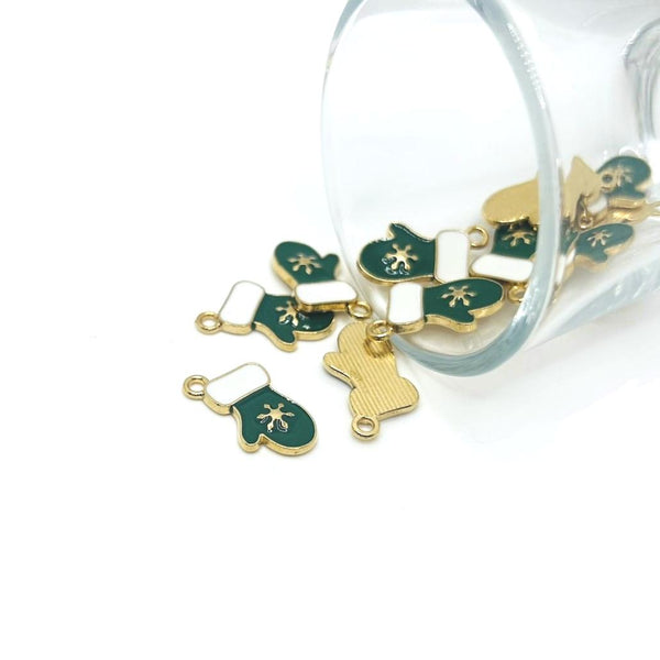 Gold and green mitten charms on a against a white background