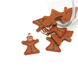 Gingerbread woman charms on a white background