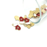 Gold and red mitten-shaped charms on a white background