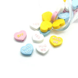 conversation heart charms on a white background