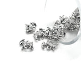 small 3D goat charms on a white background