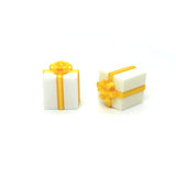 Two white gift boxes with gold ribbons and bows on a white background