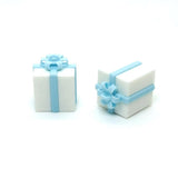 Two white gift boxes with blue ribbons on a white background
