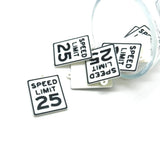 Speed limit 25 sign charms on a white background