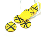 yellow rail road crossing charms on a white background
