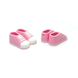 Pink baby shoes cgarn with white soles on a white background