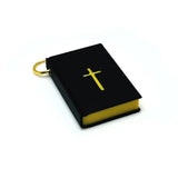 black bible charm with gold pages on a white background
