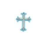 blue and silver ornate cross charm on a white background