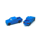 Two blue truck charms on a white background