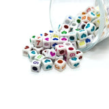 colorful alphabet beads on a white background
