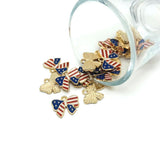 Gold and enamel ribbon charms with American flag design on a white background