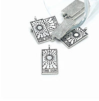 Rectangle shaped charm in antique silver with the Sun tarot card image and textured back. By Guerrilla Charm
