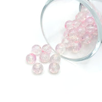 8.5 mm pink and clear crackle glass beads on a string, sparkling with textured facets—perfect for jewelry-making and craft creations.