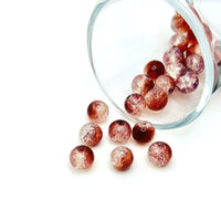 8.5 mm red and clear crackle glass beads on a string, sparkling with multifaceted cracked texture—ideal for crafting eye-catching jewelry and festive decor.