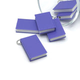 3D purple book charm measuring 27 × 18 mm with detailed cover design—ideal for jewelry, keychains, and craft projects.