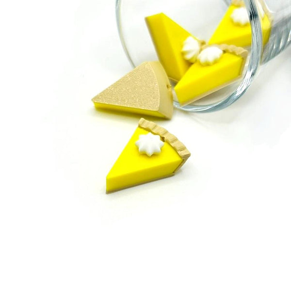 3D lemon meringue pie charm with golden crust, yellow filling, and white meringue topping, shown on a white background.
