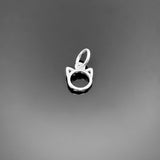 A tiny sterling silver cat charm, approximately 8 × 7 mm, with stylized cat silhouette and top loop, displayed on a clean black background.