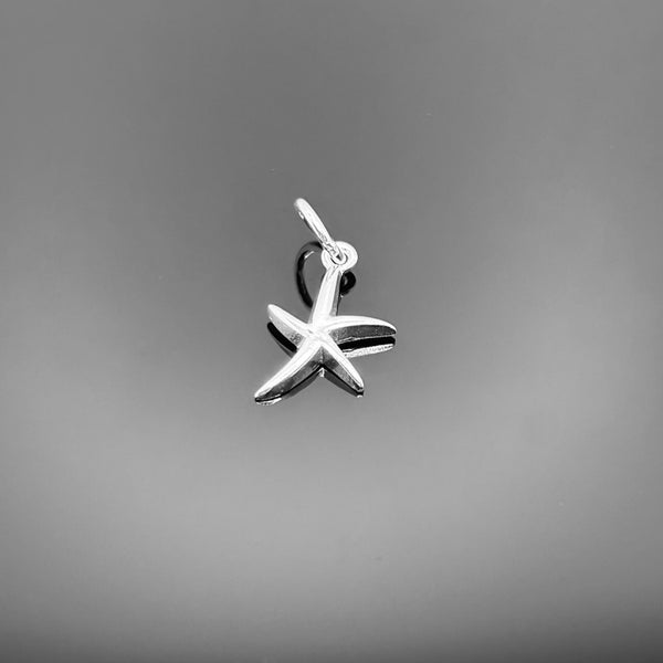 A polished sterling silver starfish charm, approximately 15×10 mm (including loop), with realistic texture and detailing, shown against a black background.