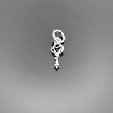 A 14×5 mm sterling silver key charm with an aged, oxidized finish, showcasing detailed grooves and a small top loop, displayed on a black background.