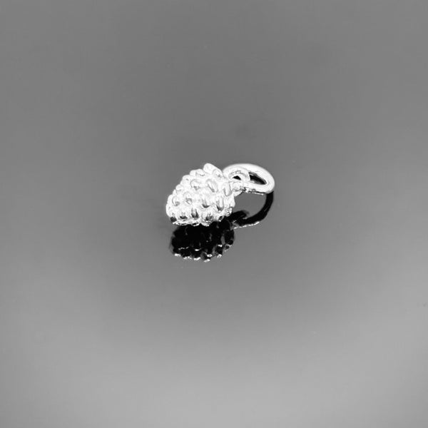 A small sterling silver pinecone charm (approx. 10×5 mm) with intricately detailed scales and an attached loop, displayed against a black background.
