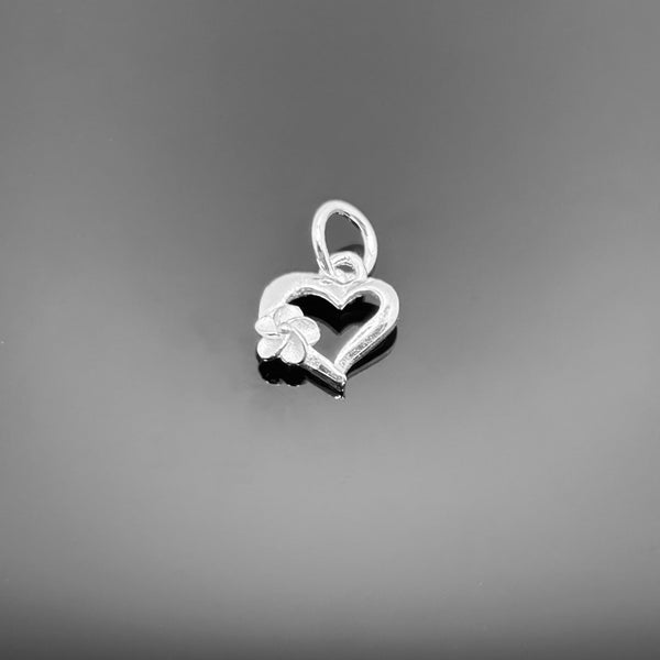 A small 10 × 9 mm sterling silver heart charm with polished finish and a top attachment loop, displayed on a black background.