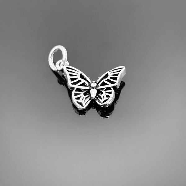 A sterling silver butterfly charm with detailed wings and a top bail, measuring approximately 17 × 14 mm, displayed on a black background.