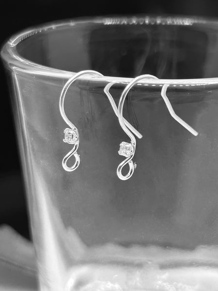 Sterling silver earring hooks with embedded rhinestones along the front curve, displayed against a white background.