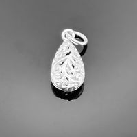 A 17×8 mm sterling silver charm with intricate filigree detailing, displayed against a clean white background.