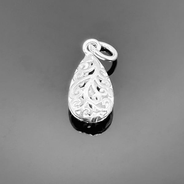A 17×8 mm sterling silver charm with intricate filigree detailing, displayed against a clean white background.