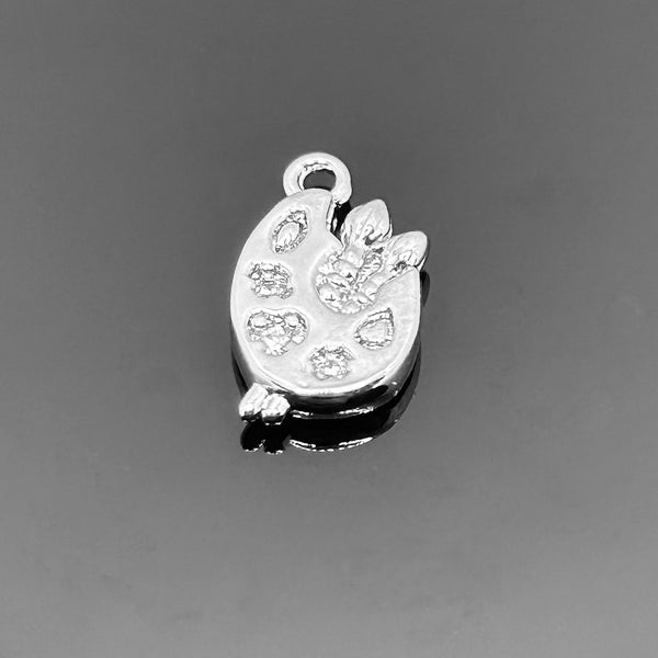 A 14 × 8 mm platinum-colored paint palette charm with smooth metallic finish, displayed against a white background—perfect for art-themed jewelry.
