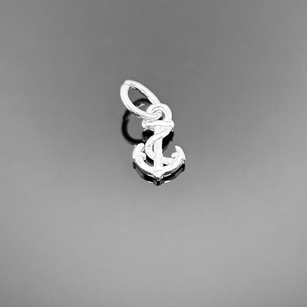 A sterling silver anchor-shaped charm with polished finish, approximately 9 × 5 mm, displayed on a clean white background.