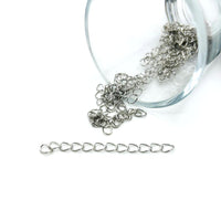 Antique silver-toned extender chain approximately 5 cm long, with oval links and lobster clasp, shown against a white background.